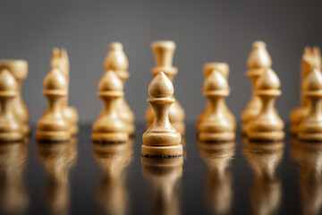 White wooden chess pieces. Pawn is in front. Focus on pawn. Reflection. Strategy. Leadership. Game....