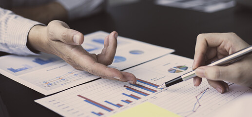 Brainstorm team, Marketers and financial accountants are discussing and analyzing charts to plan strategies to meet customer needs, Using graphs and laptops to analyze business data, Meeting concept.