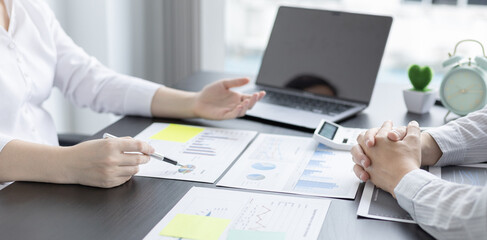 Brainstorm team, Marketers and financial accountants are discussing and analyzing charts to plan strategies to meet customer needs, Using graphs and laptops to analyze business data, Meeting concept.