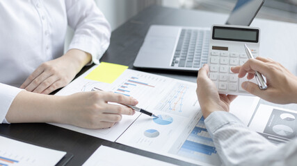 Brainstorm team, Marketers and financial accountants are discussing and analyzing charts to plan strategies to meet customer needs, Using graphs and laptops to analyze business data, Meeting concept.