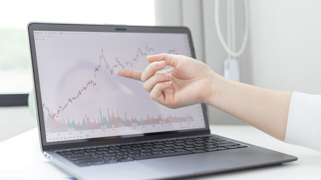 Investors sit and watch graphs of stock market data and watch the world market chart change, Investing in cryptocurrency in the stock market, Business people work on tablets and laptops.
