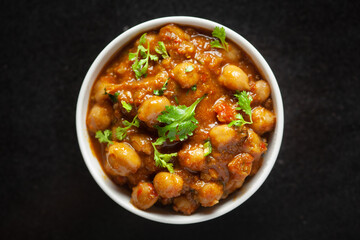 Chickpeas masala (Spicy chola or chhole curry)  garnished with fresh green coriander and...
