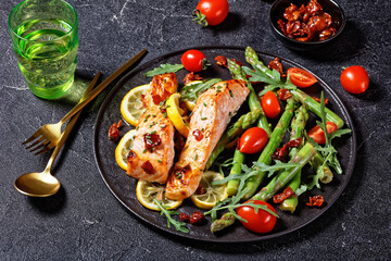 grilled salmon fillets with lemon, bacon,vegetables