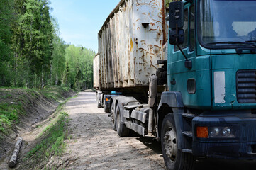 Trucks move along a country road