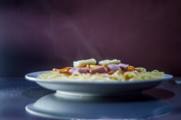 Pasta on plate with brown background