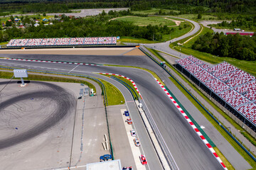 a panoramic view of the avodrome for racing in sports cars before the races on a sunny day filmed from a drone 