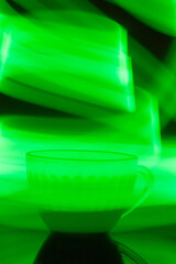 cup of coffee with green light around it