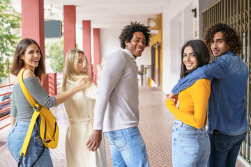 Multi-ethnic group of friends walking together on the street.