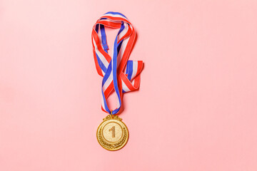 Simply flat lay design winner or champion gold trophy medal isolated on pink colorful background....