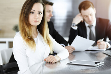Fototapeta premium Business woman headshot in sunny office. Unknown businesswoman sitting behind computer monitor