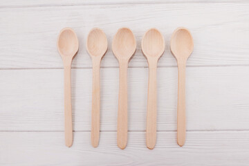 wooden spoons on white boards.