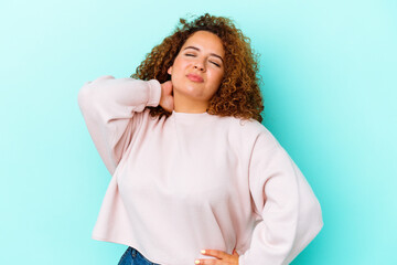 Young latin curvy woman isolated on blue background having a neck pain due to stress, massaging and...