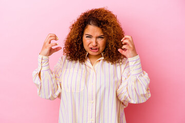 Young latin curvy woman isolated on pink background upset screaming with tense hands.