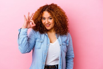 Young latin curvy woman isolated on pink background cheerful and confident showing ok gesture.
