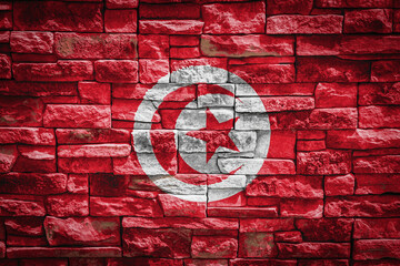 National flag of Tunisia  on stone  wall background.The concept of national pride and symbol of the...