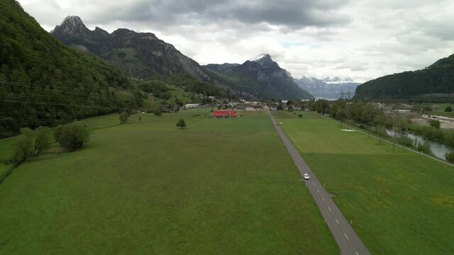 Establishing shot of a wonderful mountain lake panorama in Switzerland, aerial.