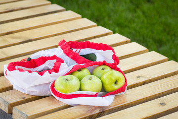 Apples and beans in sustainable eco bag. Ecological shopping and zero waste life style concept