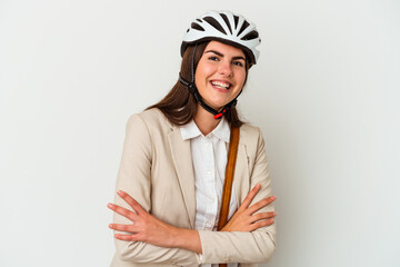 Young caucasian woman riding a bicycle to work isolated on white background laughing and having fun.