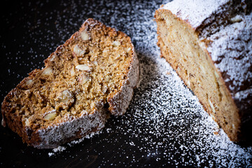 A close up of a loaf of banana bread with surrounding sugar.