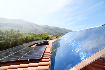 Renewable energy system with solar panel for electricity and hot water - obrazy, fototapety, plakaty