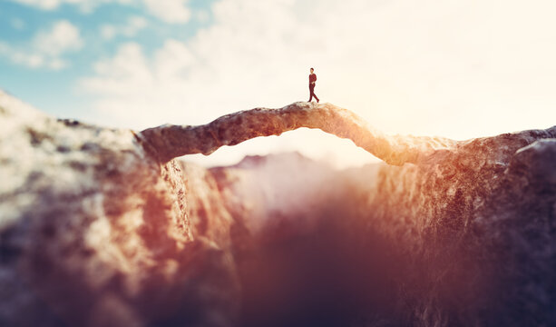 Man Walking On The Other Side Of Mountain Bridge.