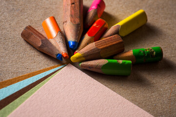 Miniature pencils and different drawing papers.