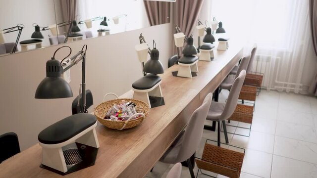 Places of masters in the manicure room in the beauty salon. Professional manicure. Hygiene and hand care. Interior of empty modern nail salon.