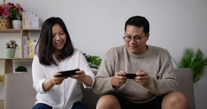 Happy couple using smartphone play mobile game