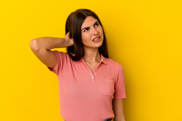 Obraz premium Young caucasian woman isolated on yellow background tired and very sleepy keeping hand on head.