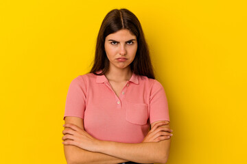 Young caucasian woman isolated on yellow background blows cheeks, has tired expression. Facial...