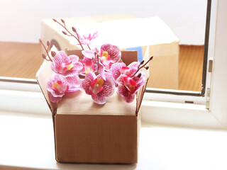 A box of orchids on the doorstep. Flower delivery.