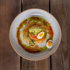 salmon tartar with egg and avocado puree