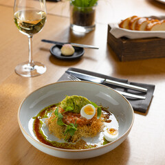 salmon tartar with egg and avocado puree