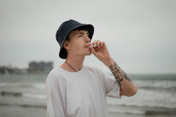 young man nervously smokes cigarettes