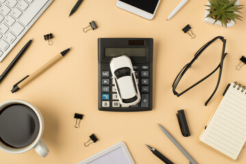 Top view photo of keyboard flowerpot pens stationery binders cup of coffee smartphone car model on...
