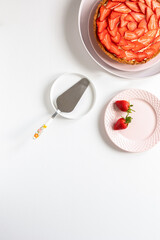 Delicious, fresh tart with custard cream and strawberries on a white table. Place for text. - 435213409