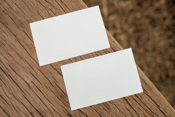 White paper business card prototype placed on wood board background