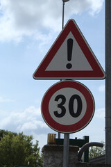 an italian road sign by day