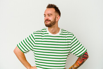 Fototapeta premium Young tattooed caucasian man isolated on white background dreaming of achieving goals and purposes