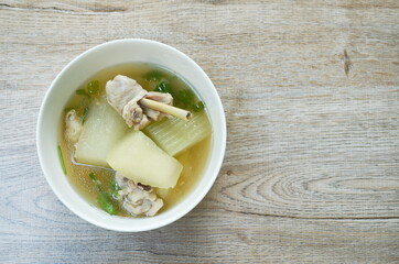 boiled winter melon with chicken leg soup on bowl