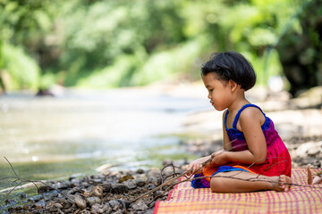 Cute little girl playing at stream