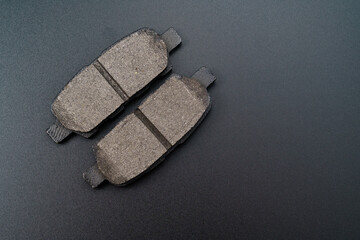 The brake pad on a black background. part of the braking system.