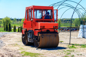 Road construction works with roller compactor machine