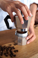 Barista Process of making natural coffee from beans with moka pot                               