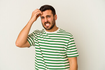 Young caucasian man isolated on white background forgetting something, slapping forehead with palm and closing eyes.