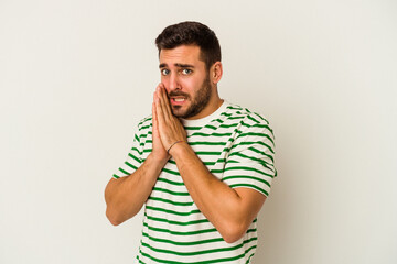 Young caucasian man isolated on white background scared and afraid.