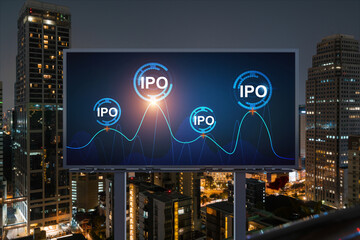 IPO icon hologram on road billboard over night panorama city view of Bangkok. The hub of initial public offering in Southeast Asia. The concept of exceeding business opportunities.