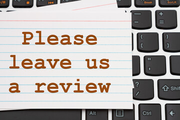 Please leave us a review message white index card on a keyboard - obrazy, fototapety, plakaty