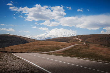 Elbrus And Green Hills with road At Sunny Summer Day. Dzhili-Su, Republic of Kabardino-Balkaria,North Caucasus, Russia.