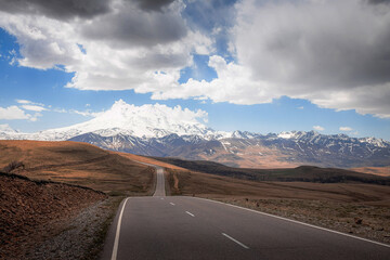 Elbrus And Green Hills with road At Sunny Summer Day. Dzhili-Su, Republic of Kabardino-Balkaria,North Caucasus, Russia.